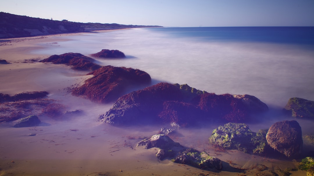 A view of a beach with rocks and water