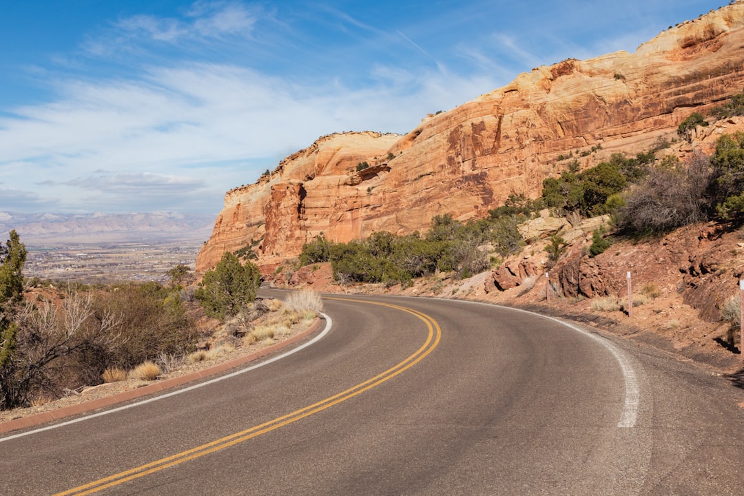 A winding road curves through a desert landscape.