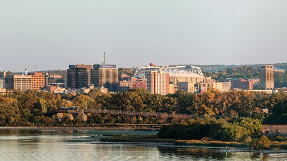 Panoramic view of Syracuse, New York skyline above Onondaga Lake during fall.