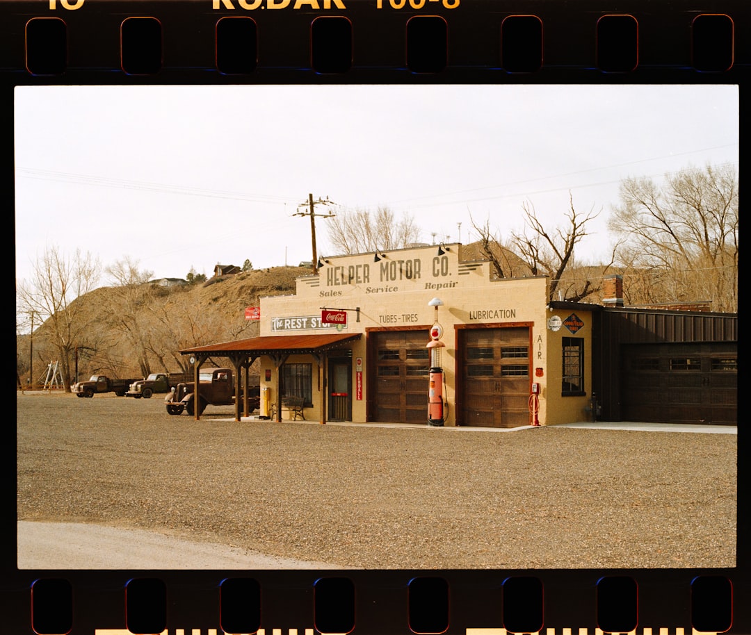 Desert gas station with vintage cars parked outside
